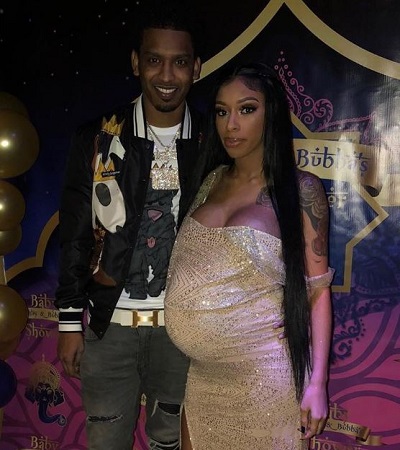 Ashley and her boyfriend posing when she was pregnant